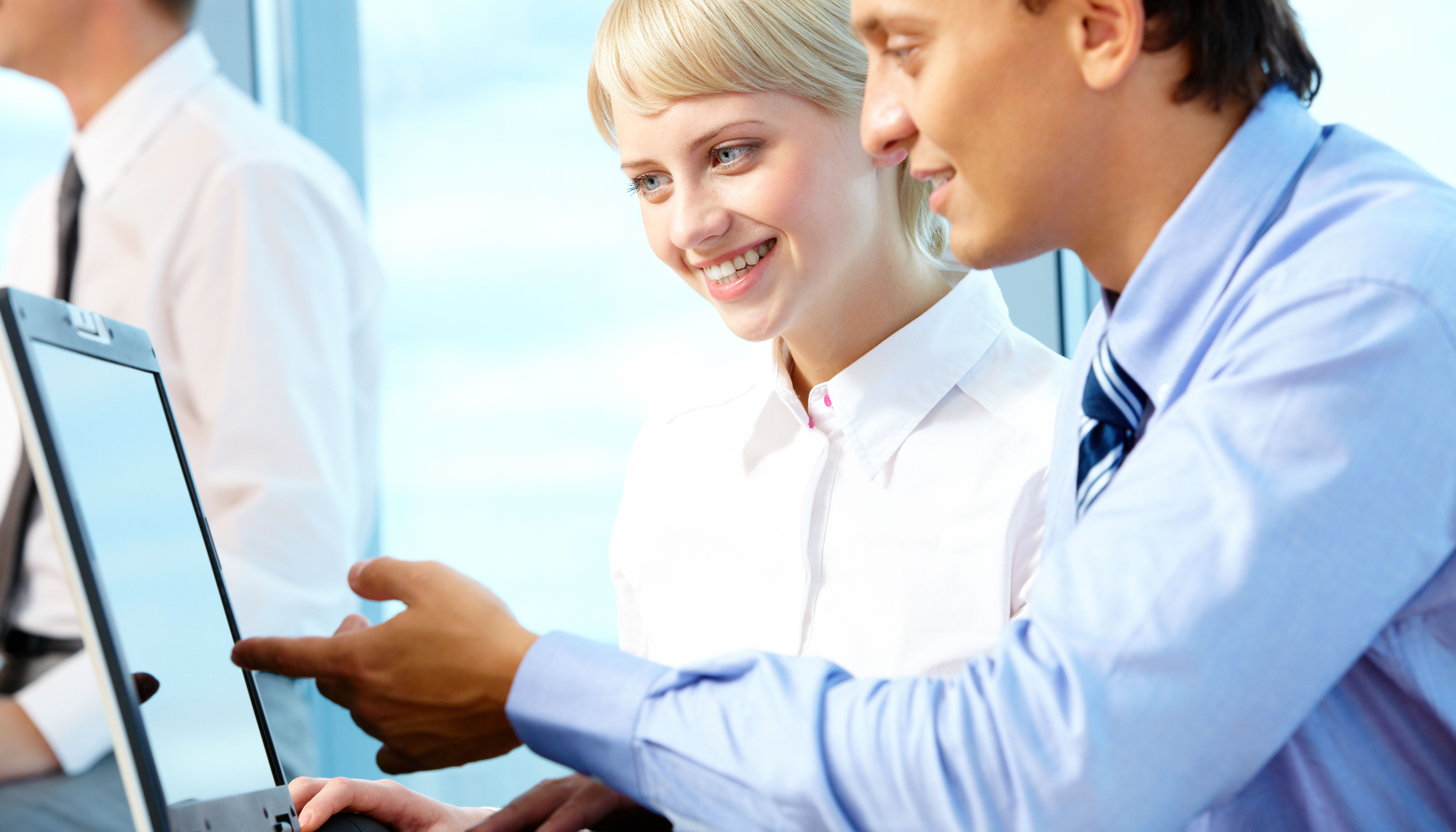 man and a woman looking at laptop